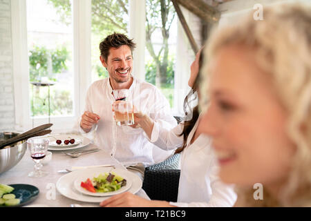 Happy family having meal together Stock Photo