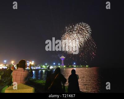 Khobar. 29th Mar, 2019. Visitors take pictures of fireworks during the Sharqiah Season by the Al-Khobar corniche in Eastern Province of Saudi Arabia, March 29, 2019. The Sharqiah Season, held in nine cities in Eastern Province, wrapped up on March 30. Over the period of 17 days, the season entailed a carefully crafted selection of over 100 programs and activities covering culture, sports, education and entertainment. Credit: Tu Yifan/Xinhua/Alamy Live News Stock Photo