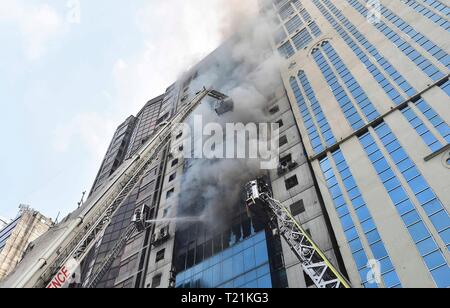 Bangladeshi firefighters extinguish a fire that broke out at Chalantika ...