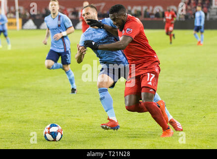 Toronto, Canada. 29th Mar, 2019. Jozy Altidore (R) of Toronto FC vies with Maxime Chanot of New York City FC during the 2019 Major League Soccer (MLS) match at BMO Field in Toronto, Canada, March 29, 2019. Toronto FC won 4-0. Credit: Zou Zheng/Xinhua/Alamy Live News Stock Photo