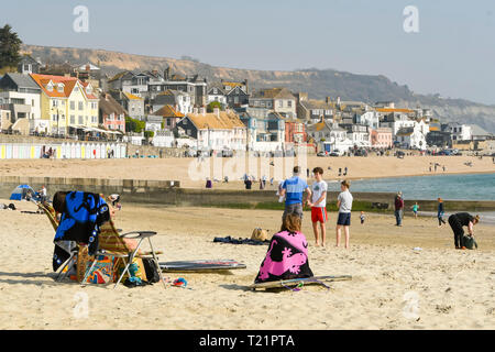 Lyme Regis, Dorset, UK. 30th Mar, 2019. UK Weather. Visitors on the beach enjoying a day of clear skies and hot spring sunshine at the seaside resort of Lyme Regis in Dorset. Picture Credit: Graham Hunt/Alamy Live News