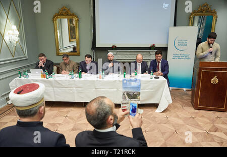 Hamburg, Germany. 30th Mar, 2019. Romas Jakubauskas (l-r), Muslim Cleric from Lithuania, Iqbal Sacranie, General Secretary of the Muslim Council of Britain (MCB), Abduhl-Vakhed Niyazov, President of the Forum, Gamal Fouda, Imam from Christchurch, New Zealand, Malik Ruiz, Conference Leader, and a translator sit at one table during the Conference of European Muslims. Credit: Georg Wendt/dpa/Alamy Live News Stock Photo