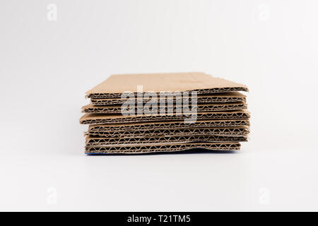 corrugated cardboard for packing isolated on white. abstract background horizontal lines with wavy lines of beige color Stock Photo