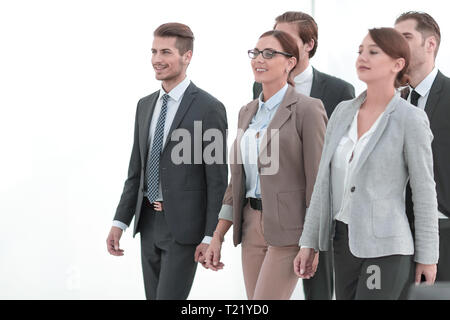 group of employees of the company confidently passes through the office hall Stock Photo