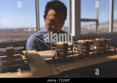 Male architect looking at architectural model in a modern office Stock Photo