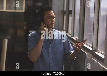 Male architect talking on mobile phone in a modern office Stock Photo