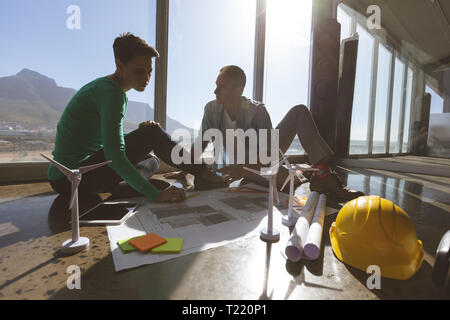 Architects discussing about blueprints at office Stock Photo