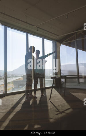Architects discussing over digital tablet in office Stock Photo