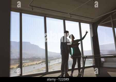 Architects discussing over digital tablet in office Stock Photo