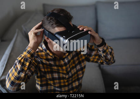 Man using virtual reality headset at home Stock Photo