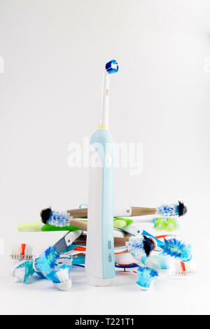 Manual regular Toothbrush Against Modern Electric Toothbrush. Isolated on White Background. Manual used tuthbrushes background Stock Photo