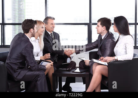 employees look at the handshake of business partners .the concept of solidarity Stock Photo