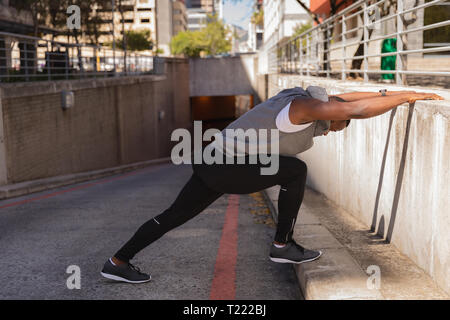 Man doing exercise on street Stock Photo