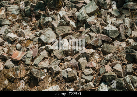 Bunch of rough stones lying on the slope at the Monfrague National Park. A remarkable place with a charming mountain ridge in Spain. Stock Photo
