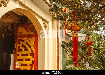 Red and gold carps hanging near Buddhist temple in Old Quarter - decoration for celebrating Tet, Vietnamese new year in Hanoi, Vietnam. Stock Photo