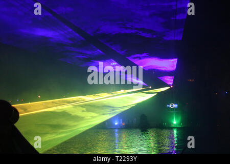 Laser beams during a public show in several colors at the water of the Ringvaart (Ring canal) Zuidplaspolder in Nieuwerkerk aan den IJssel Stock Photo