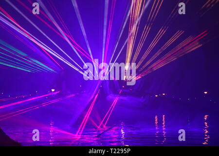 Laser beams during a public show in several colors at the water of the Ringvaart (Ring canal) Zuidplaspolder in Nieuwerkerk aan den IJssel Stock Photo