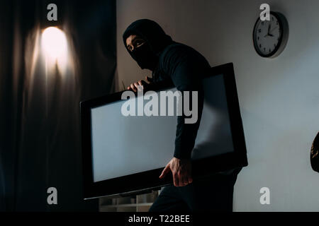 Download Robber In Black Mask Stealing Flat Screen Tv With Blank Screen Stock Photo Alamy PSD Mockup Templates