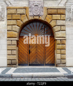 Arched doorway and heavy wooden door in Prague Castle, Prague, Czech Republic. Old, historic European architecture travel landmarks. Stock Photo