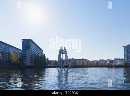 Germany, Berlin, view to Treptow with sculpture 'Molecule Man' and River Spree in the foreground Stock Photo