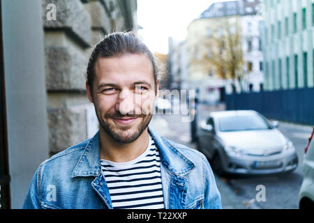 Portrait of bearded young man smiling Stock Photo