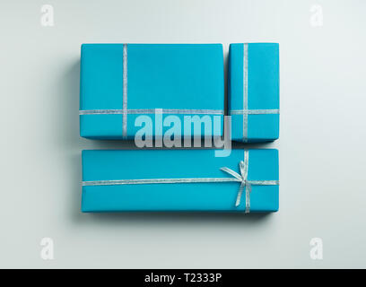 Three Blue Gift Wrapped Gifts with silver ribbon Stock Photo