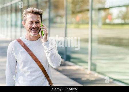 Mature man commuiting in the city, talking on the phone Stock Photo
