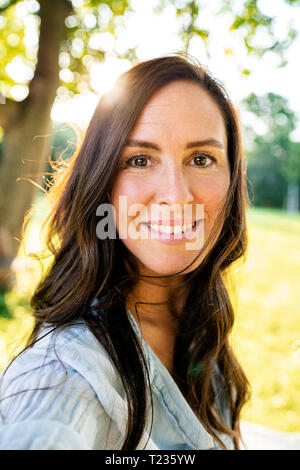 Portrait of smiling mature woman in garden Stock Photo