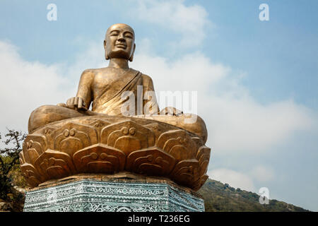 Golden statue of Buddha sitting in a lotus flower at ancient Buddhist complex at Yen Tu Mountain, Quang Ninh Province, Vietnam. Stock Photo