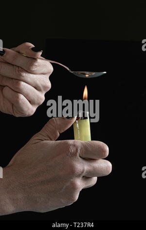 Heating heroin in spoon. Stock Photo