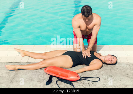 Lifeguard doing resuscitation procedure. Toned image. Stock Photo