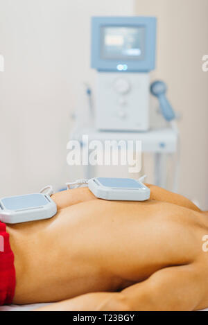 Magnetotherapy. Magnets on patient's back. Stock Photo