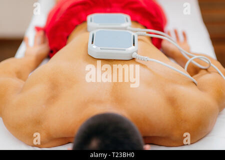 Magnetotherapy. Magnets on patient's back. Stock Photo
