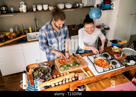 Young couple preparing food together, tasting spaghetti Stock Photo