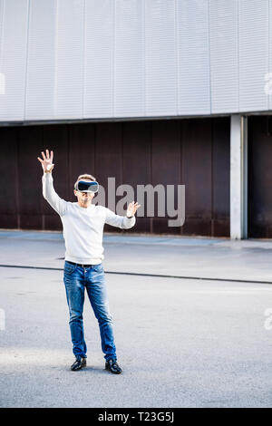 Mature man using VR glasses Stock Photo