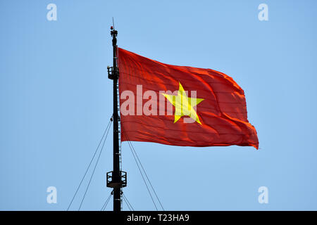 Huge Flag of Vietnam on the wind ona sunny day in Hue, Vietnam. Red flag with yellow star. Stock Photo