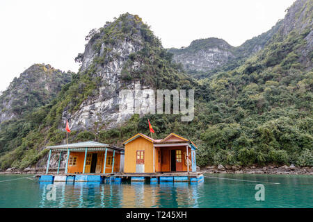 Colorful fishermen houses on the water in Halong Bay (Ha Long Bay) in Northern Vietnam. Day time. Stock Photo