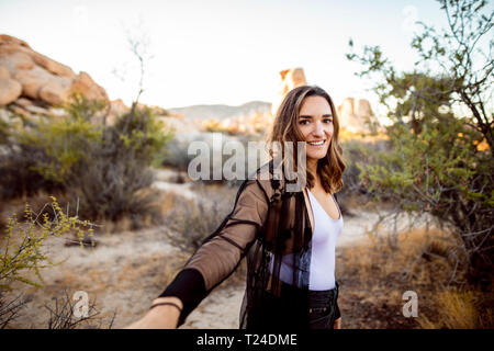 USA, California, Los Angeles, portrait of smiling woman in Joshua Tree National Park Stock Photo