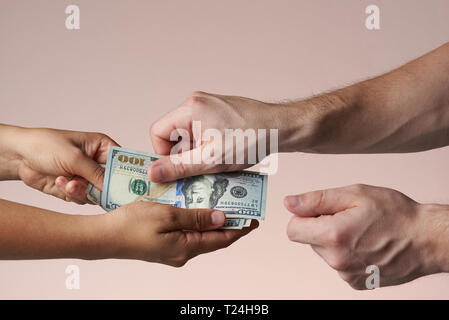 Pay with cash concept. One person give money to other person Stock Photo