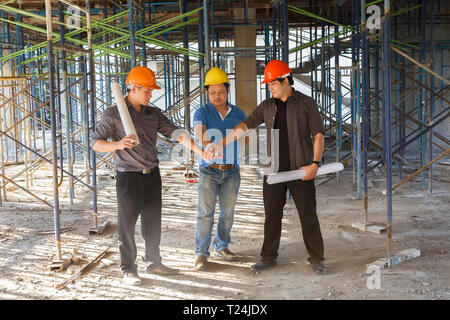 Team of professional engineers foreman and worker working on construction site. Portrait of construction team on site Stock Photo