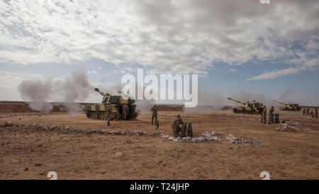 Members of the Royal Moroccan Armed Forces demonstrate training methods with M109A5 howitzers for Soldiers from the Utah National Guard’s 1st Battalion, 145th Field Artillery Regiment; Idaho National Guard’s 1st Battalion, 148th Field Artillery Regiments;  and 1st Battalion, 320th Field Artillery Regiment, 2nd Brigade Combat Team, 101st Airborne Division, during exercise African Lion 2019, near Tan Tan, Morocco, March 26, 2019. This annual exercise is a combined- multi-national event focused on improving mutual understanding while demonstrating the strong bond between the nations’ militaries.  Stock Photo