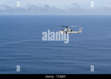 190328-N-NB544-1241 PACIFIC OCEAN (March 28, 2019) An AH-1Z Cobra, assigned to Marine Medium Tiltrotor Squadron (VMM) 163 (Reinforced), flies over the Pacific Ocean during a live-fire exercise. John P. Murtha is underway conducting routine operations as a part of USS Boxer Amphibious Ready Group (ARG) in the eastern Pacific Ocean. (U.S. Navy photo by Mass Communication Specialist 2nd Class Kyle Carlstrom) Stock Photo