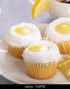 Closeup of cupcakes with lemon filling and white icing on a  plate Stock Photo