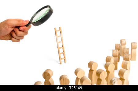 Magnifying glass is looking at the group of people looking at the ladder. career ladder. Promotion at work, business, self-development, leadership ski Stock Photo