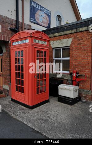 A vintage Giles Gilbert Scott's K2 red telephone box and Avery parcel scales at Bewdley Station at the Severn Valley Railway Shropshire Stock Photo