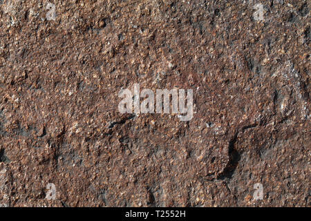 Texture of a red exterior wall of a building in a closeup. Photographed under natural light during daytime in Switzerland. Beautiful details. Stock Photo