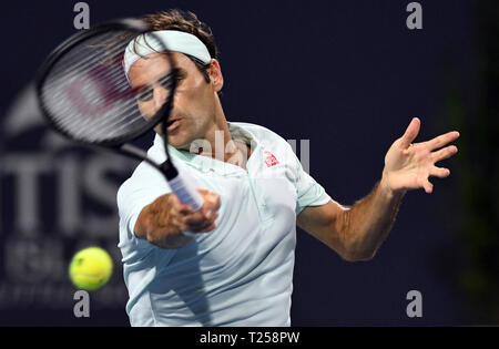 Roger Federer, of Switzerland, hits a forehand to Denis Shapovalov, of Canada, during the semifinals of the Miami Open tennis tournament Friday, March 29, 2019, in Miami Gardens, Fla. (AP Photo/Jim Rassol) Stock Photo