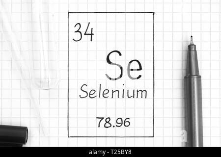 The Periodic table of elements. Handwriting chemical element Selenium Se with black pen, test tube and pipette. Close-up. Stock Photo