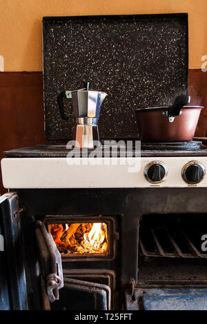 Brewing coffee in a moka pot on a wood fired stove, Bulgaria Stock Photo