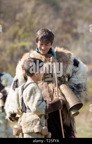 VARVARA, BULGARIA - MARCH 24, 2019: Moment from National Festival Dervish Varvara presents traditions of Bulgarian Kuker Games. Man and boy dressed in Stock Photo